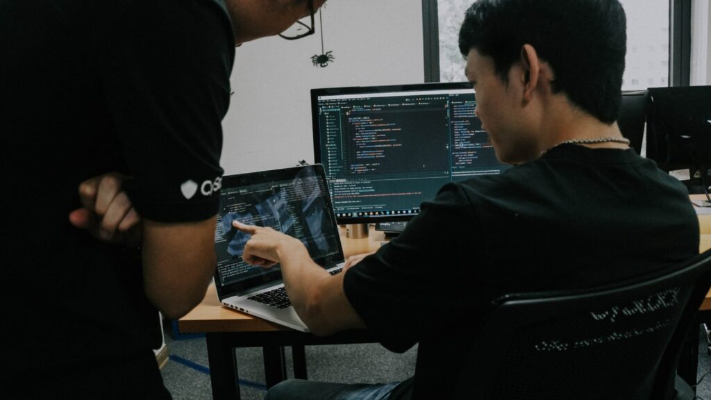 Engineers collaborating around a screen